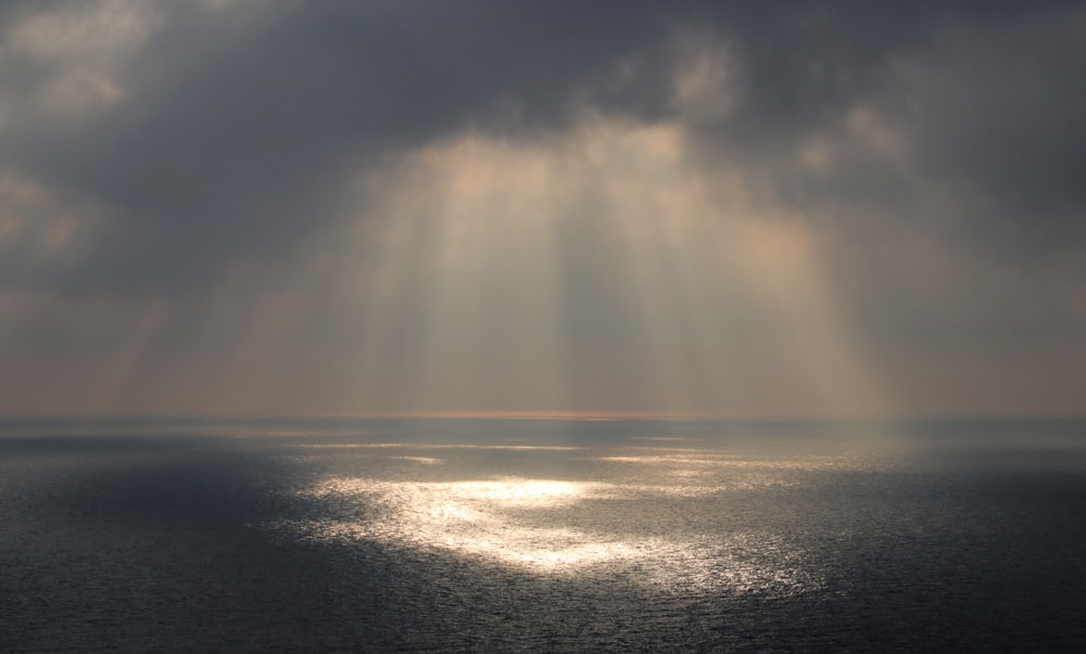 a large body of water under a cloudy sky