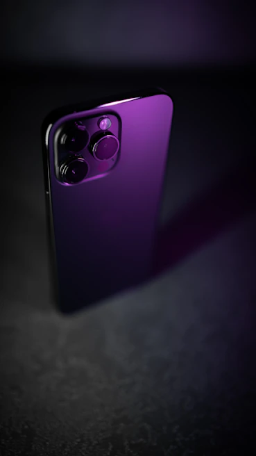 A sleek smartphone with a newly repaired back glass shining under soft lighting on a wooden table