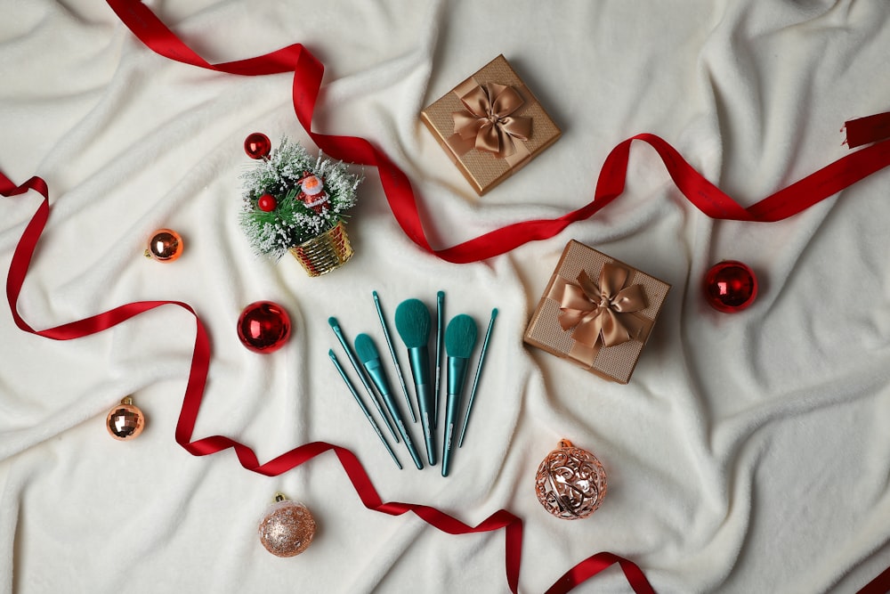 a table topped with christmas decorations and wrapped in red ribbon