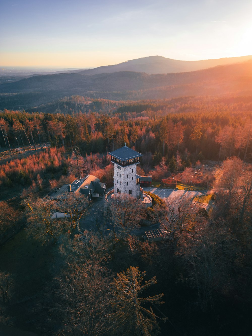 an aerial view of a building in the middle of a forest