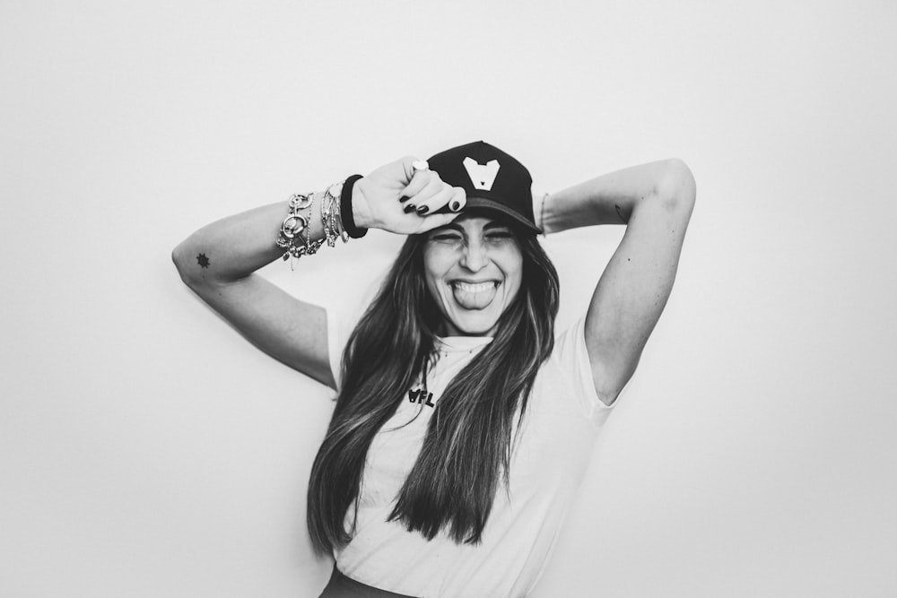 a black and white photo of a woman wearing a hat