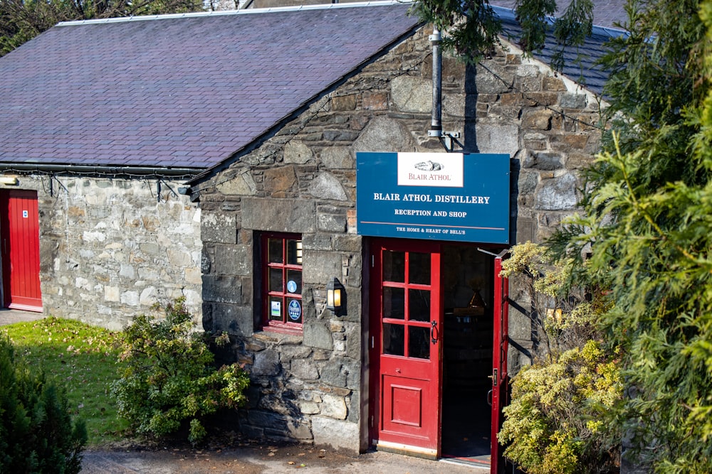 a stone building with red doors and windows