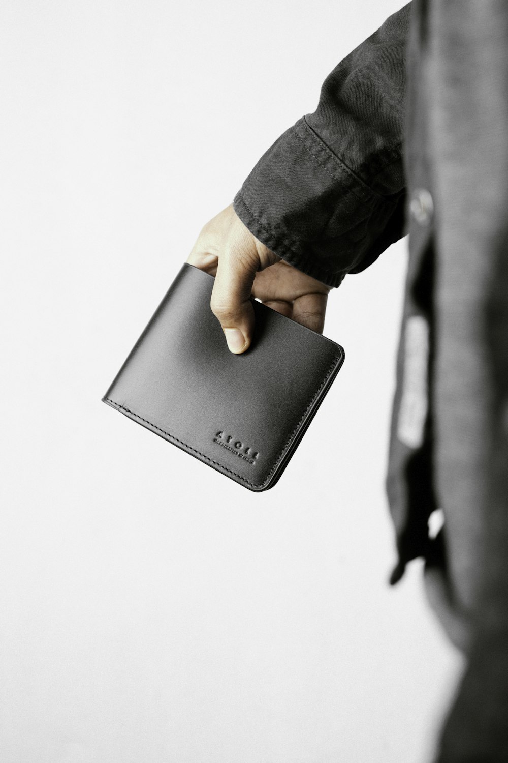 a person holding a wallet in their hand