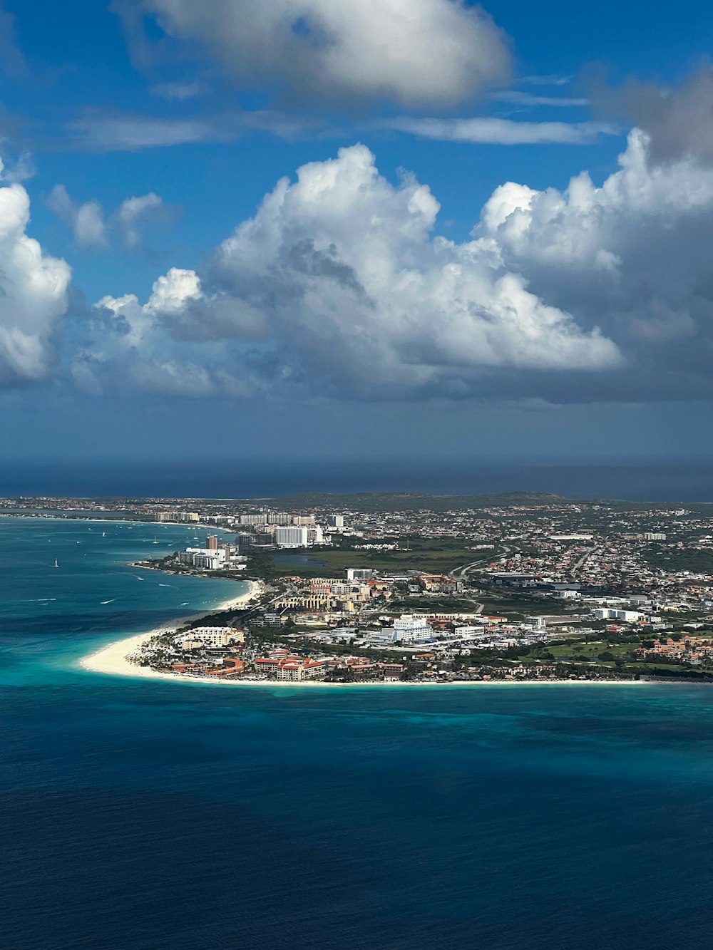 an aerial view of a city and the ocean