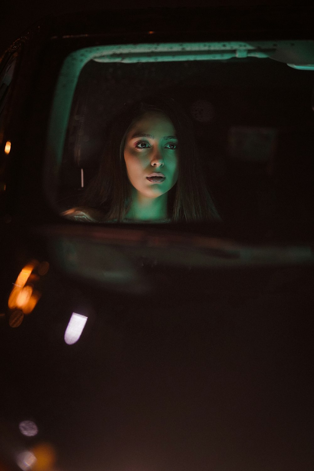 a woman in a car looking out the window