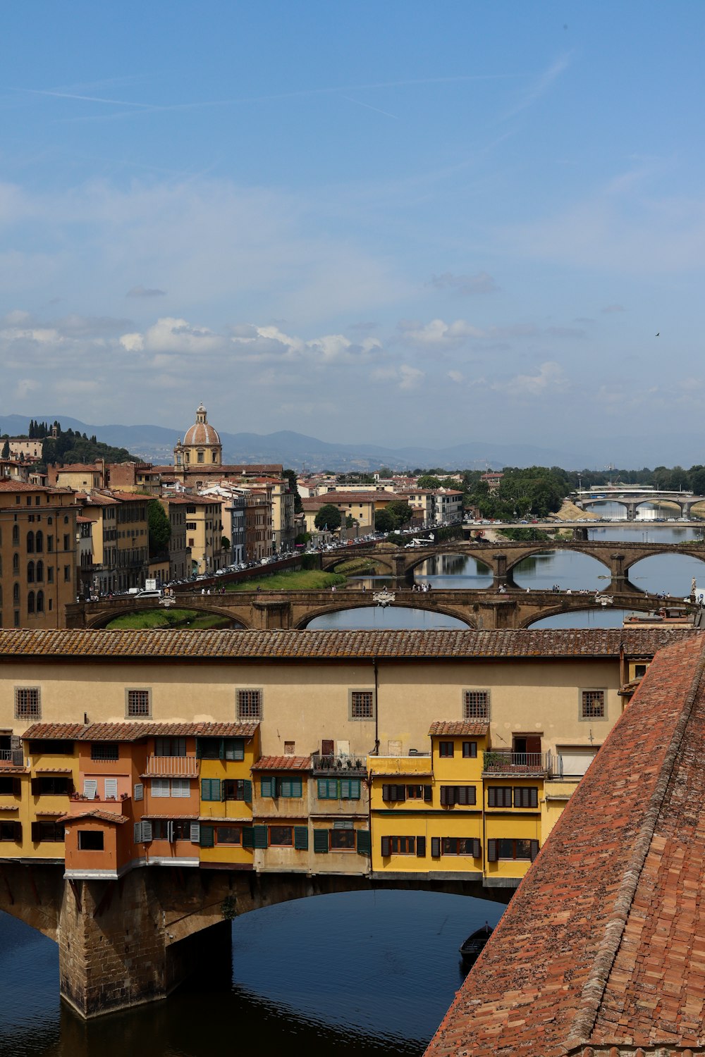 a bridge over a river with buildings in the background