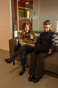 A mentor and mentee sharing ideas over coffee in a cozy, modern workspace.