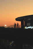 Handshake between two business partners against the backdrop of Dubai's skyline at sunset.