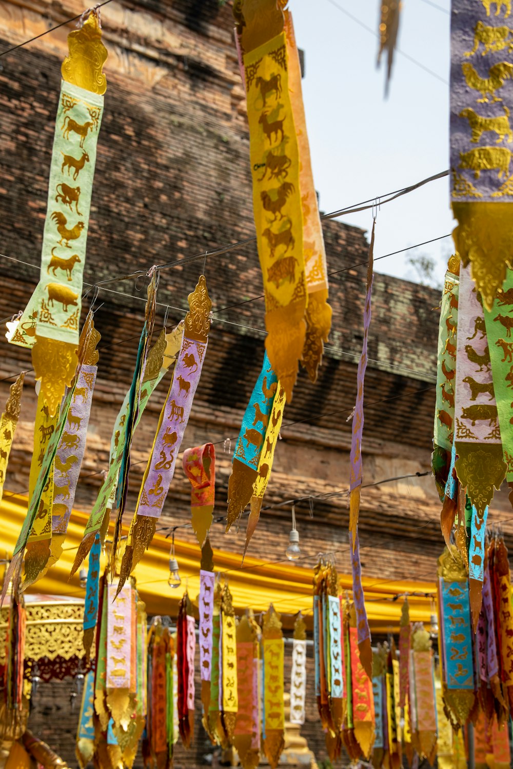 a bunch of colorful ribbons hanging from a line