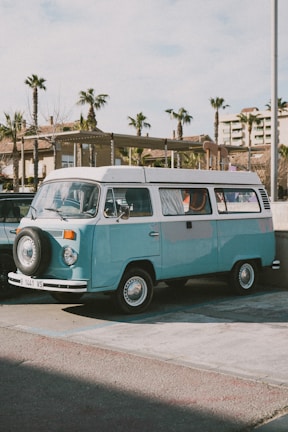 A vintage VW bus parked in a sunny outdoor setting.