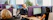 A vibrant office scene with a friendly team answering calls and emails, showcasing dynamic international business communication.