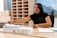 A student reviewing application materials at a desk, looking focused and determined.
