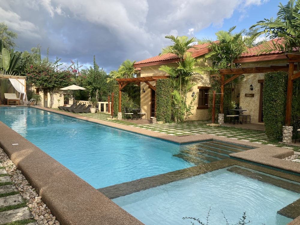 a large swimming pool surrounded by palm trees