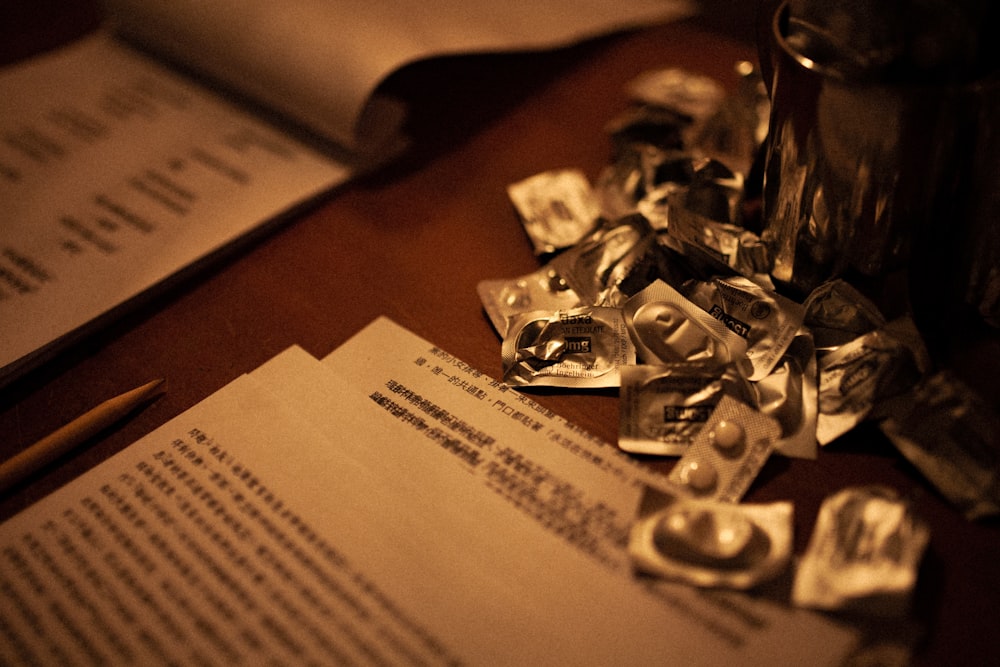 a pile of silver foil sitting on top of a wooden table