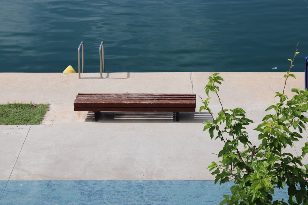 a wooden bench sitting next to a body of water