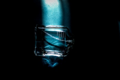 Ji Yoo Cosmetics blue light protective glow spray bottle with fresh flowers around