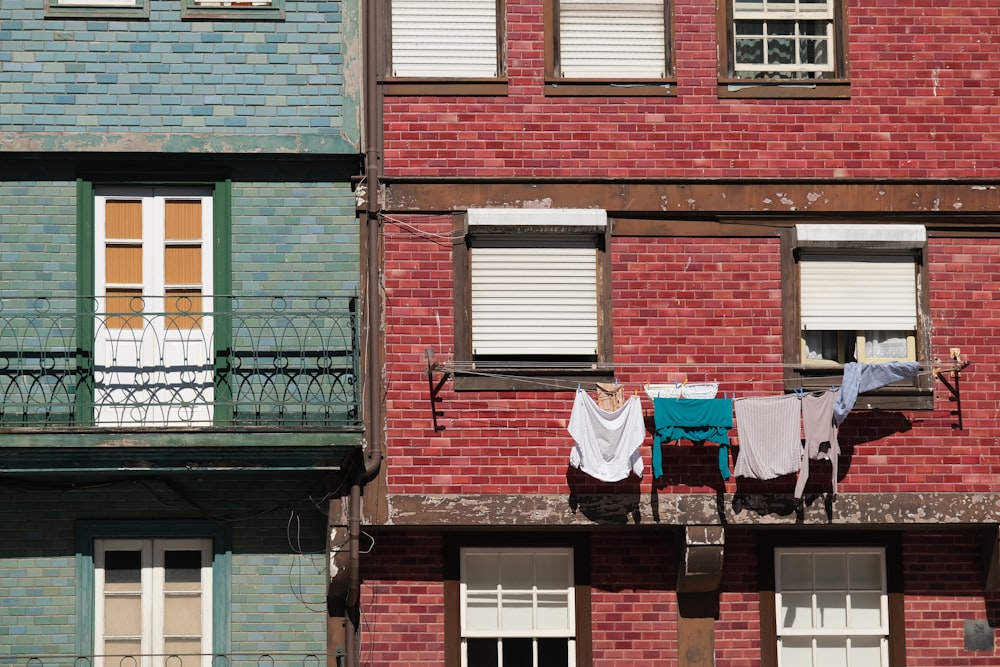 clothes hanging out to dry in front of a red brick building