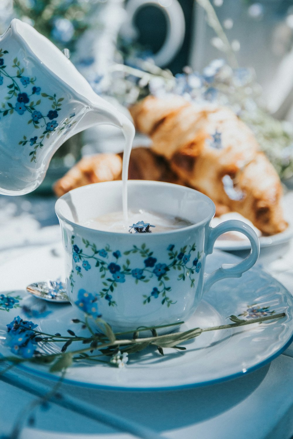 a cup of tea being poured into it