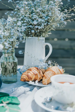 Sunlit breakfast nook with fresh flowers and homemade pastries