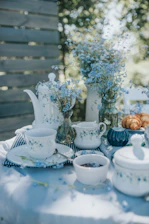 An inviting tea ceremony scene showcasing delicate porcelain cups and scenic garden background.