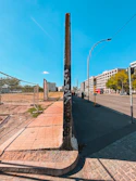 a pole with graffiti on it on the side of a road