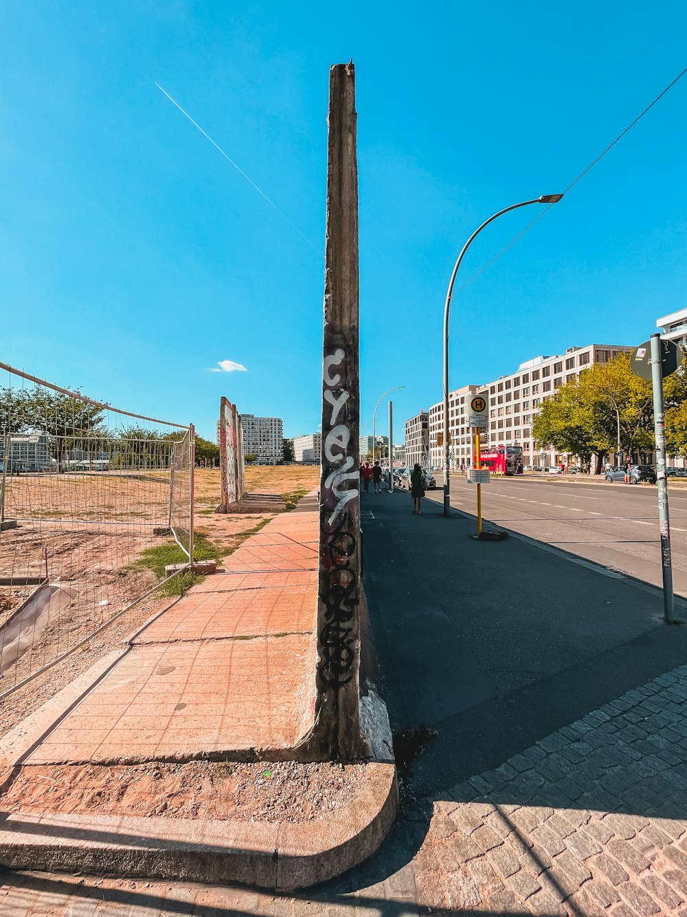 a pole with graffiti on it on the side of a road