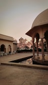 A peaceful virtual courtyard where visitors gather in quiet reflection under a twilight sky.