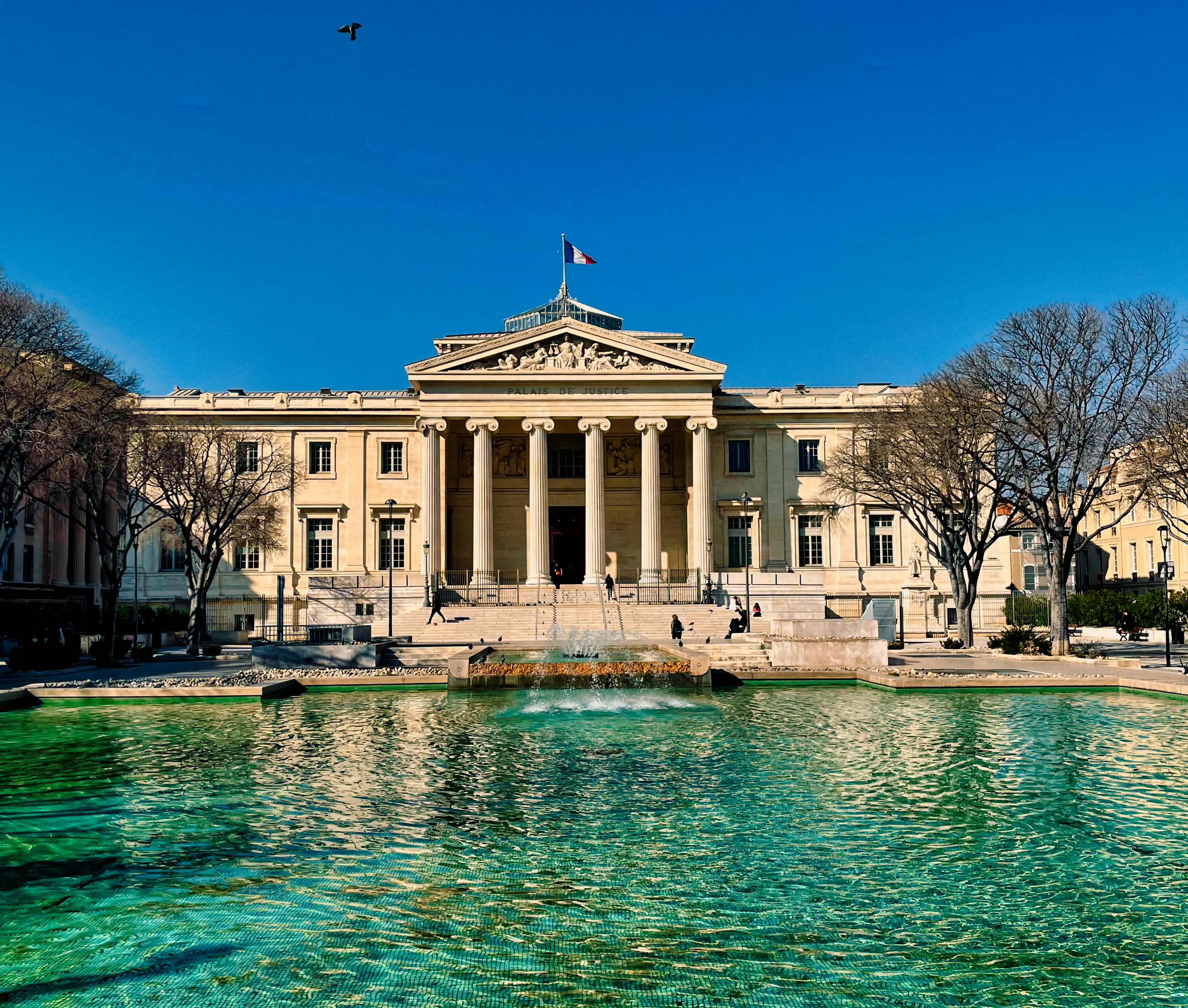 a large building with a fountain in front of it