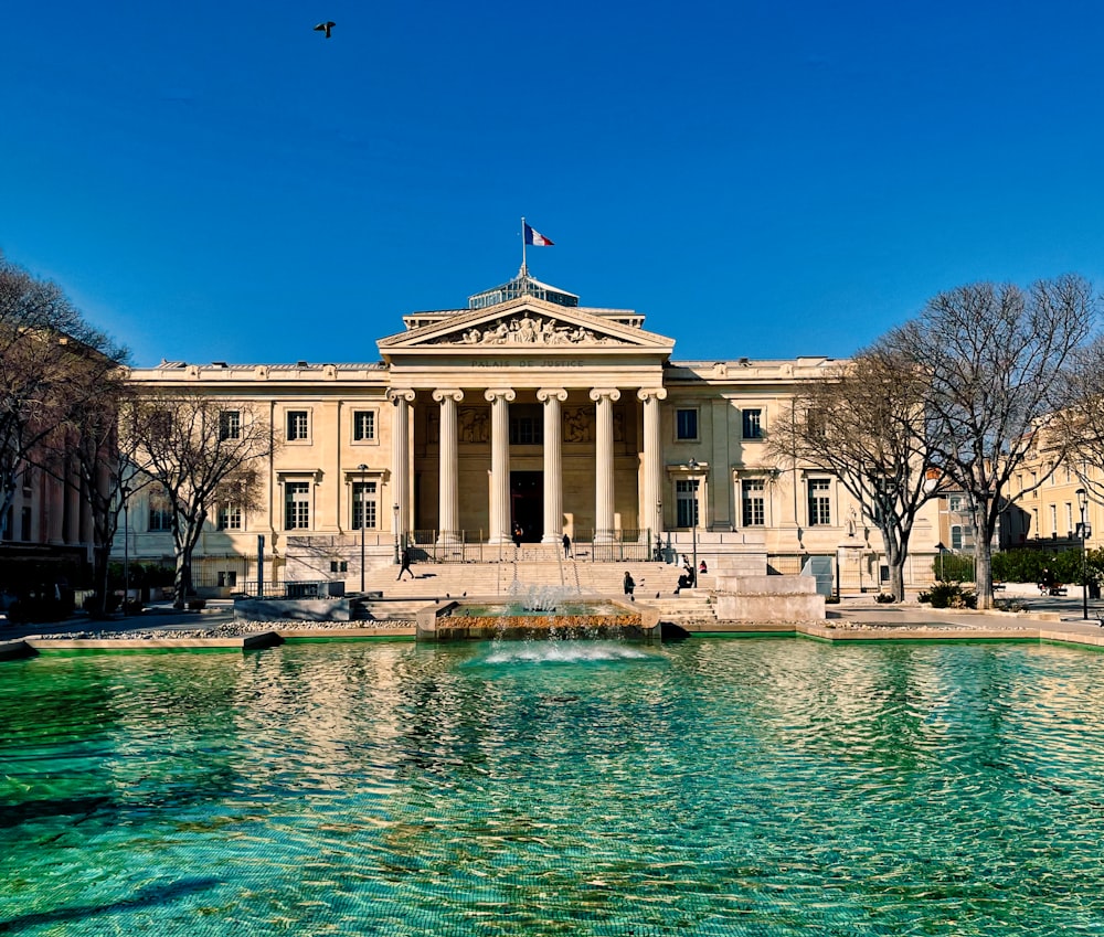 a large building with a fountain in front of it