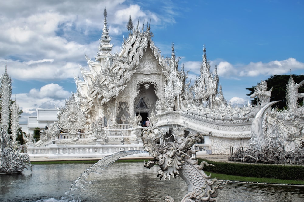 a white building with a fountain in front of it