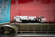 Damaged car fender with visible dents before restoration.