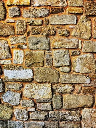 Close-up photo of stone masonry detailing on a garden wall.