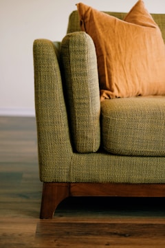 a close up of a couch with pillows on it