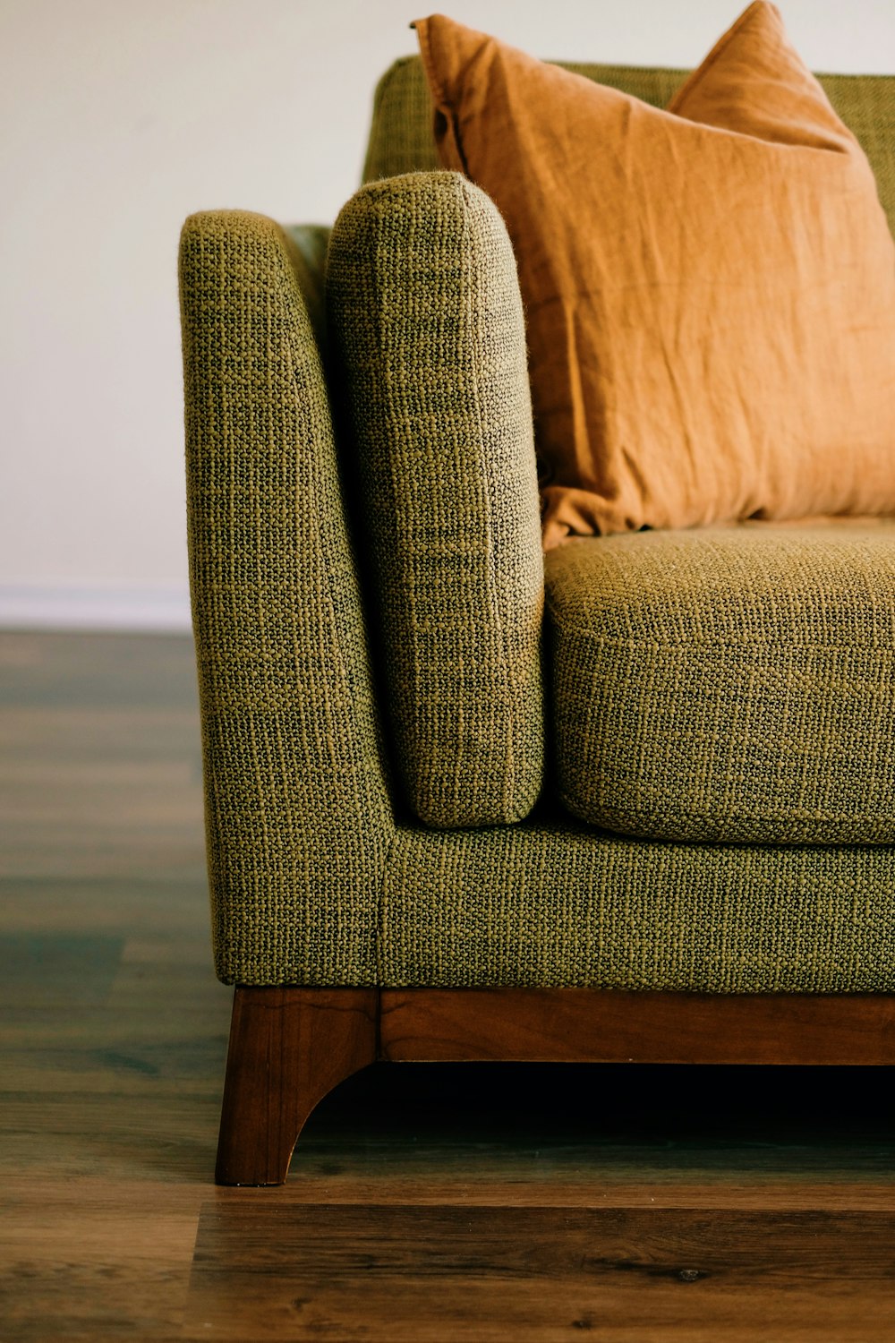 a close up of a couch with pillows on it