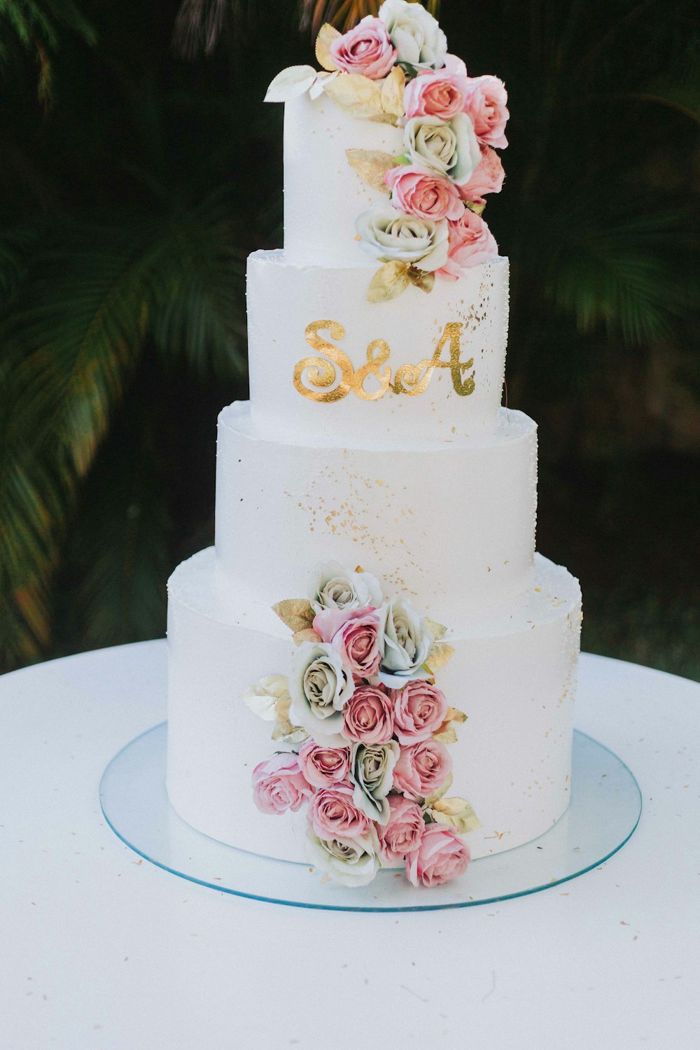 a wedding cake with flowers on top of it
