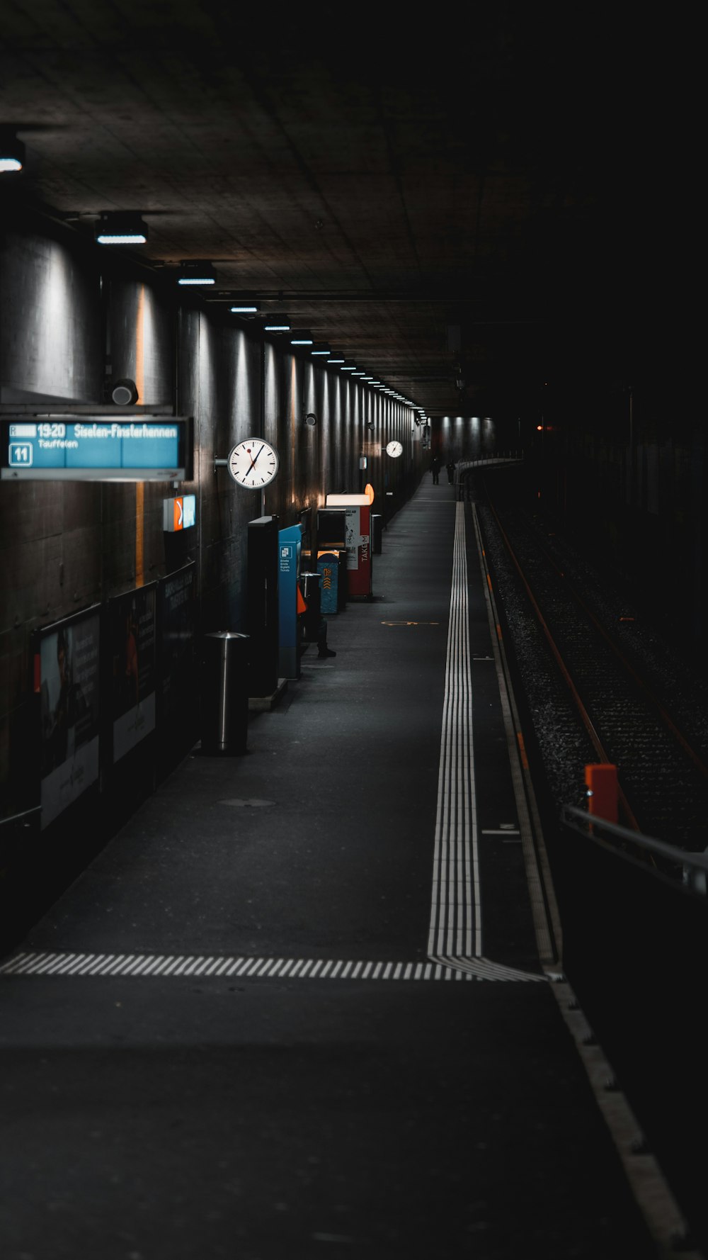 a train station with a clock on the wall