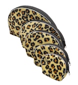 A set of small pouches with playful prints arranged on a cozy fabric background.