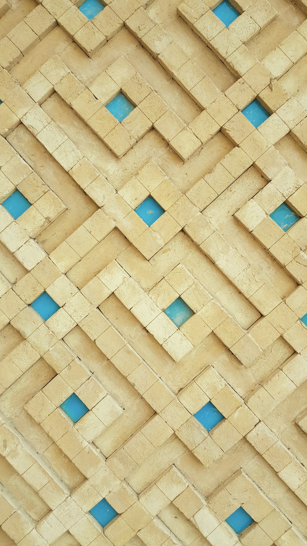 a close up of a wooden wall with blue squares