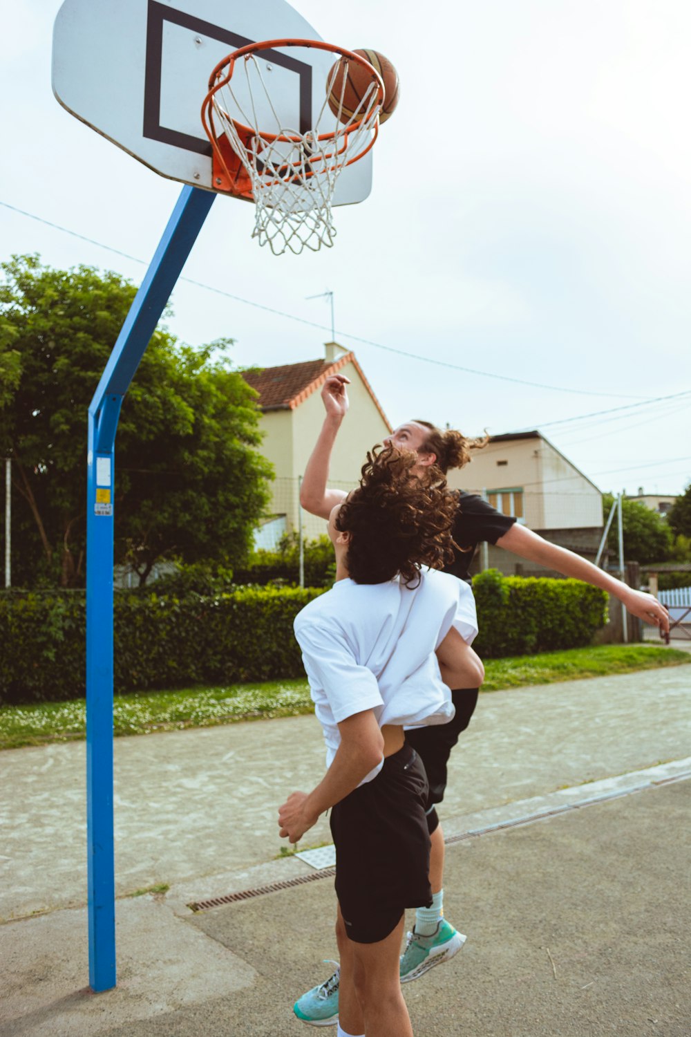 a couple of people that are playing with a basketball