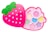 A pink, strawberry-shaped makeup kit with a green leafy top, featuring compartments with pastel-colored eyeshadows and shapes like stars and circles. The design is playful and colorful, aimed at children.