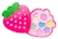 A pink, strawberry-shaped makeup kit with a green leafy top, featuring compartments with pastel-colored eyeshadows and shapes like stars and circles. The design is playful and colorful, aimed at children.
