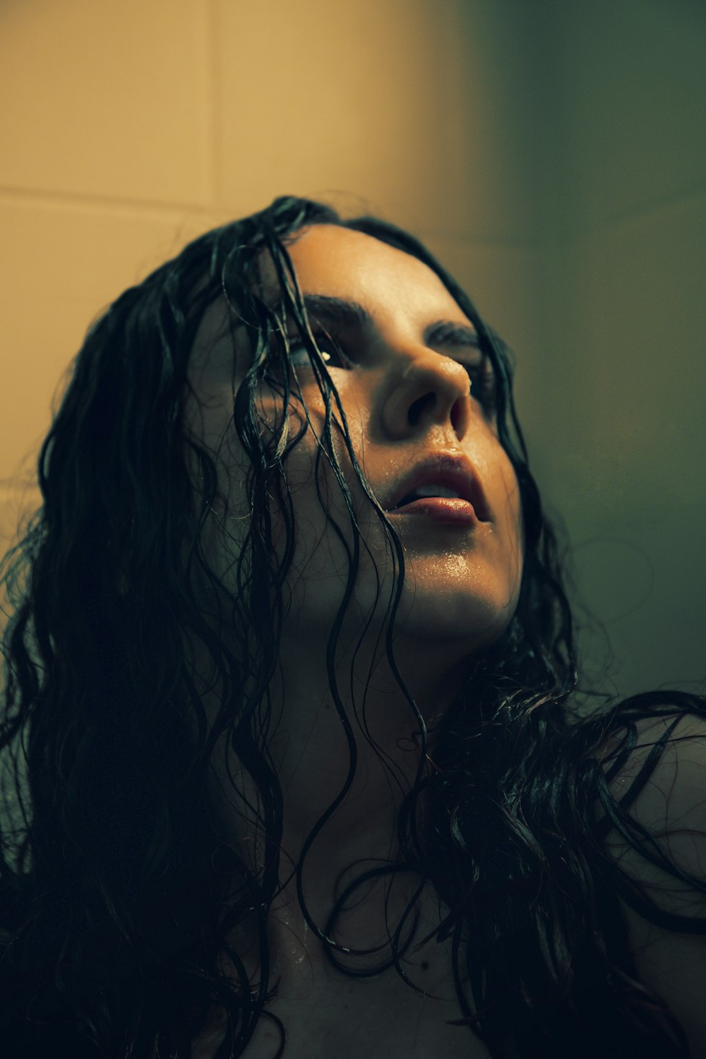 a woman with wet hair standing in a bathroom