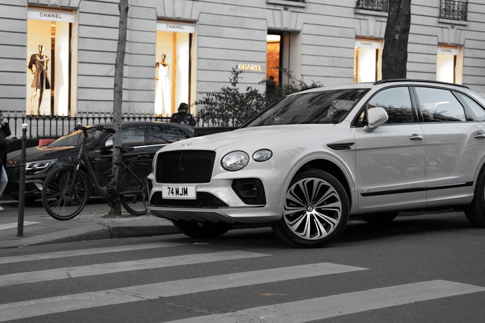 a white suv parked on the side of the road