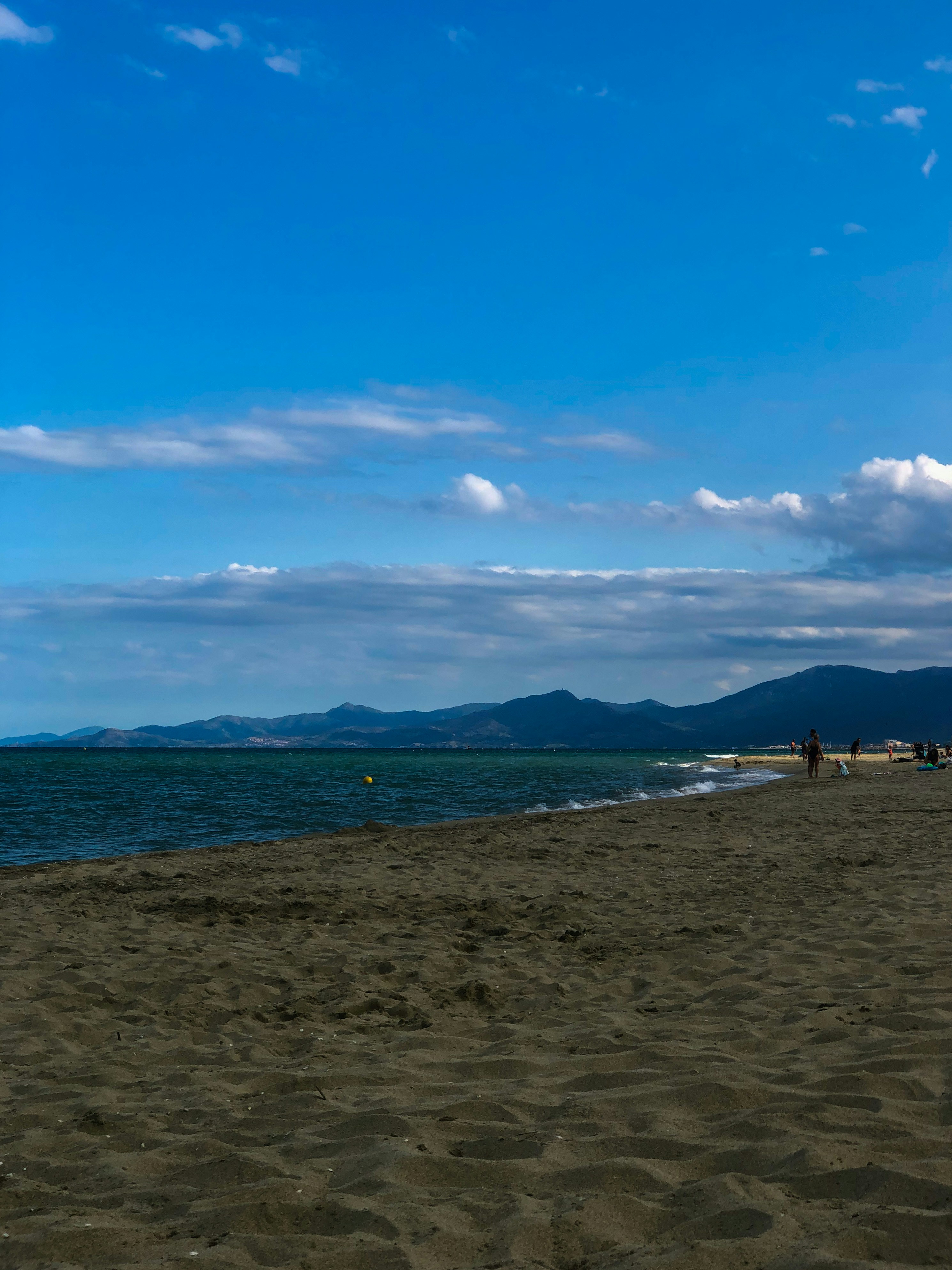a person on a beach flying a kite
