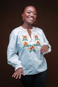 A joyful woman wearing statement artificial earrings at a lively party, glowing with confidence.