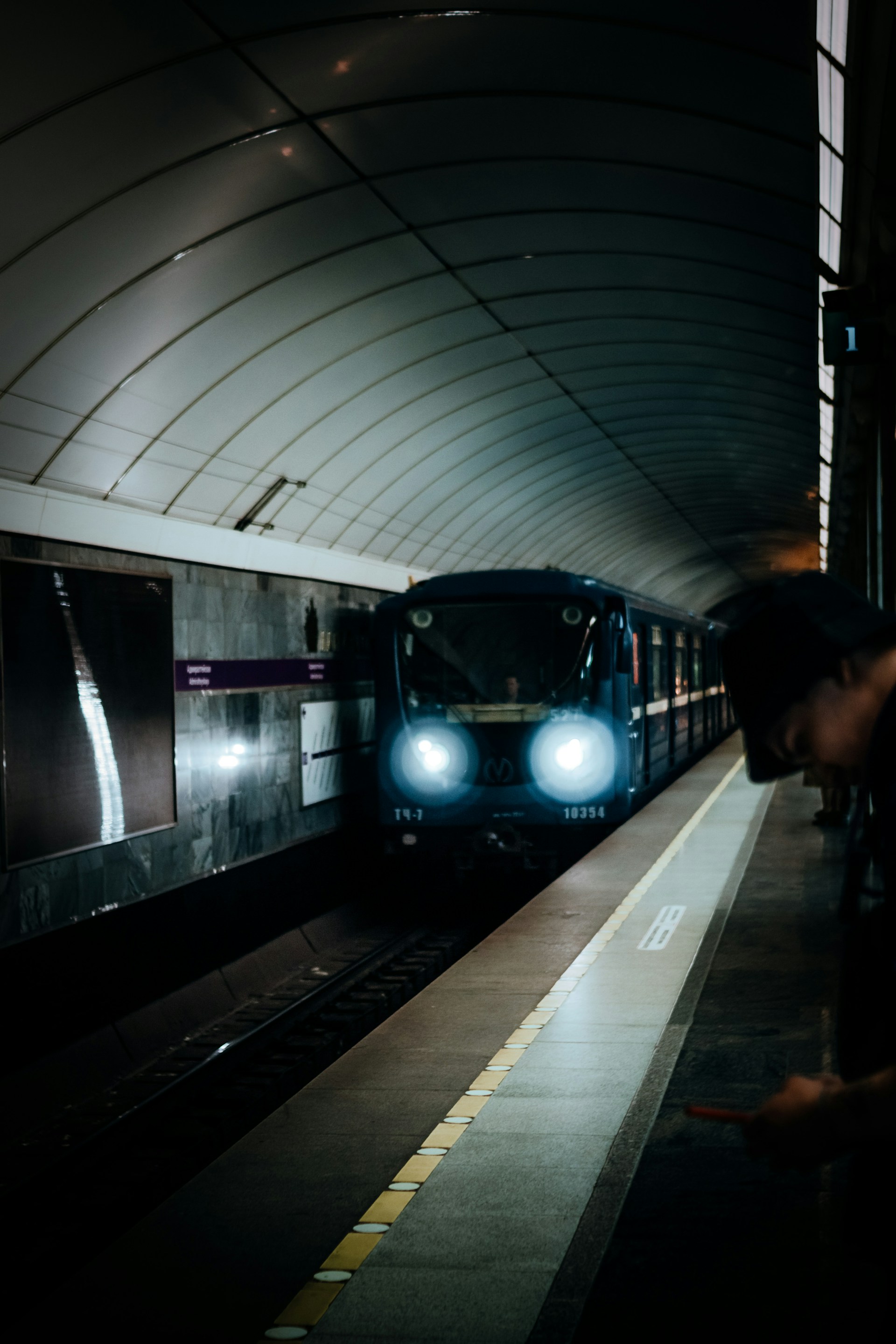 a train pulling into a train station at night