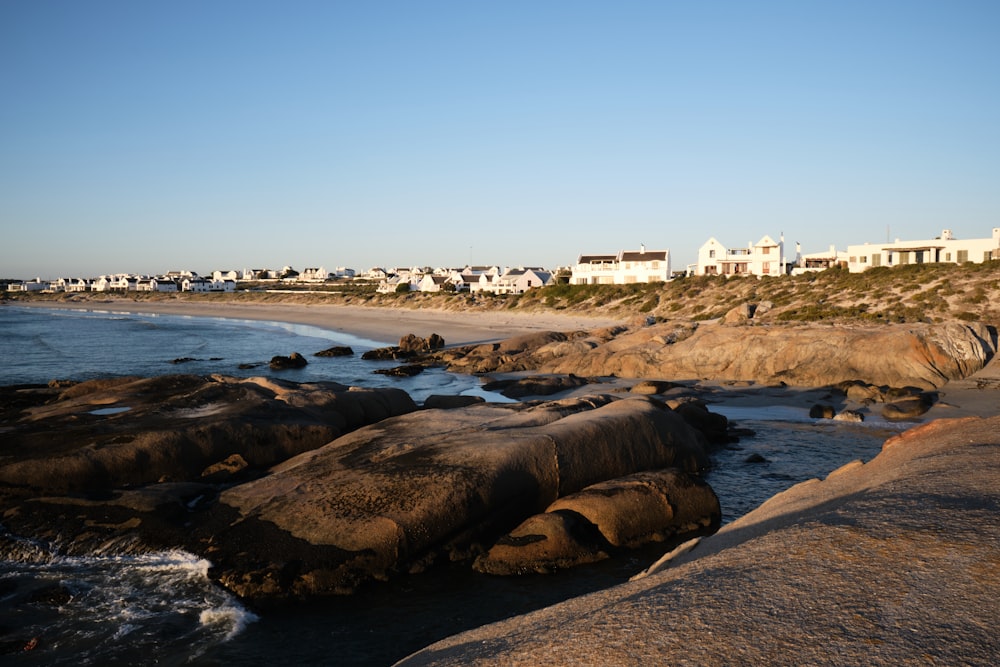 a view of a beach with houses in the background