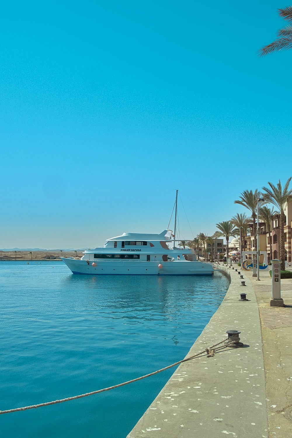 a large boat is docked at a pier