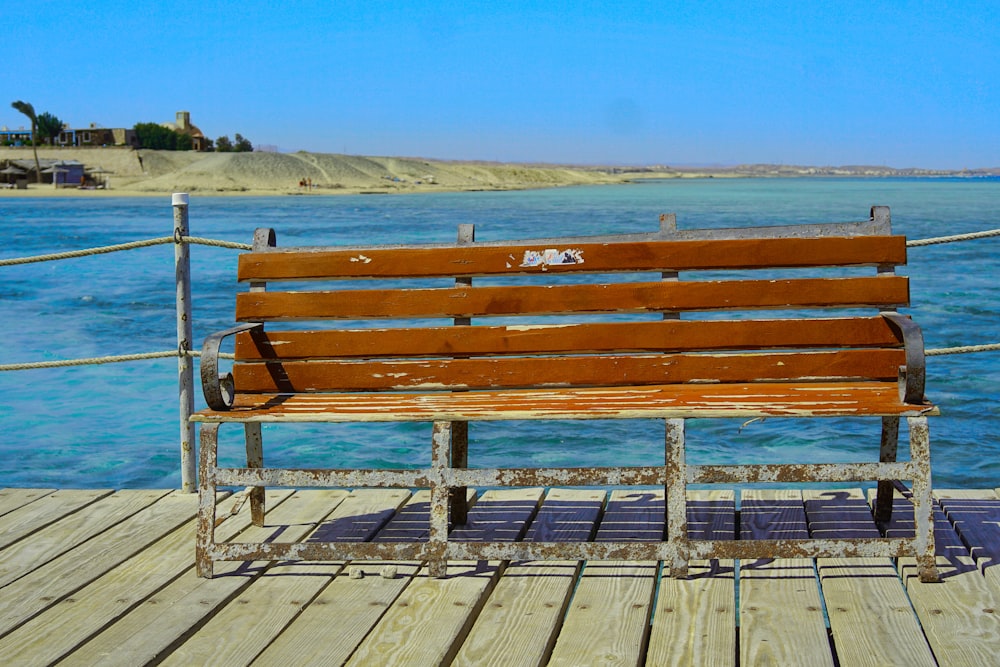 a wooden bench sitting on top of a wooden pier