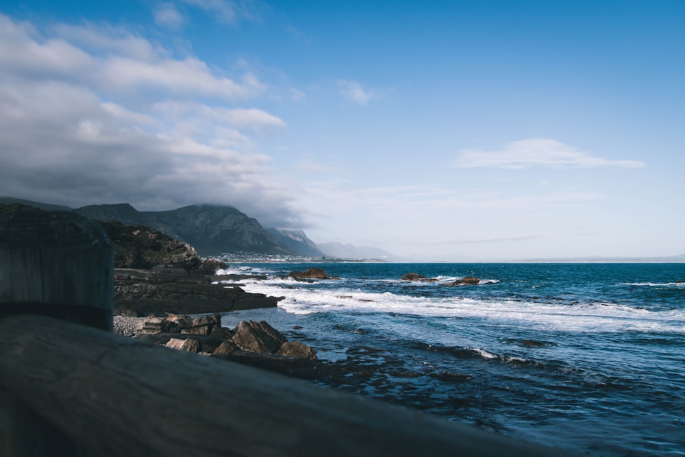 a body of water near a rocky shore